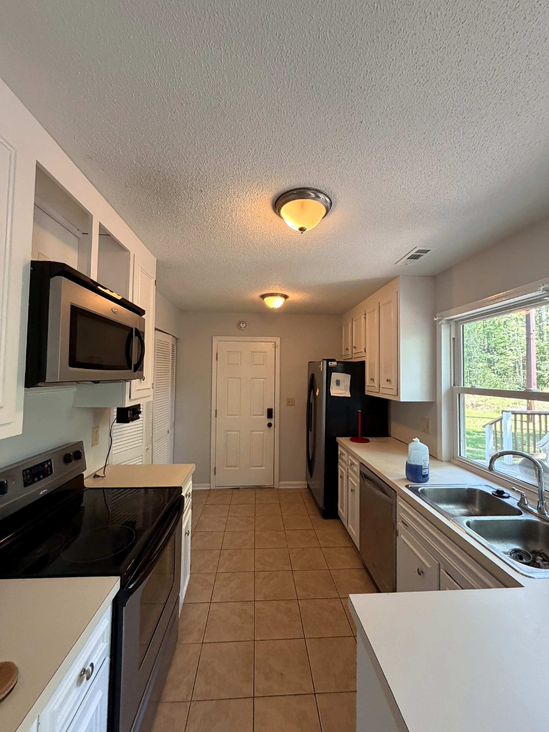 Kitchen with cabinets refinished in a smooth white factory-style finish